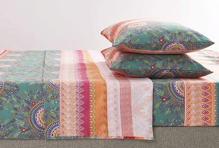colorful stripe patterned boho sheets on bed