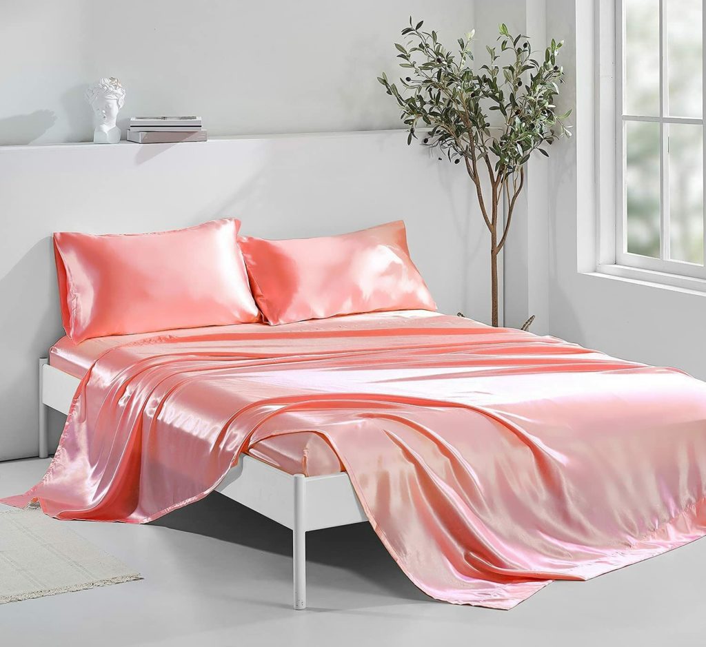 coral pink satin sheets on bed