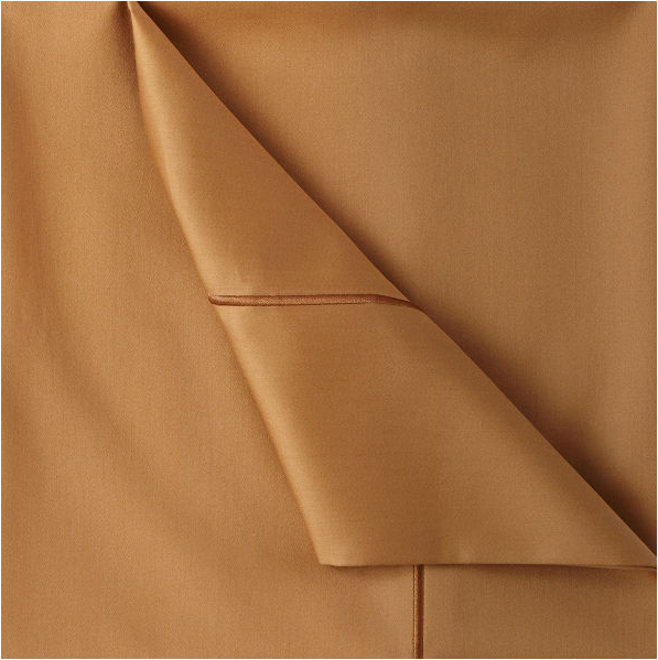 corner of camel colored sheets with piping detail