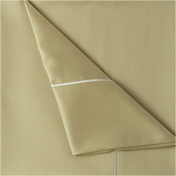 corner of sage green sheets with white piping detail