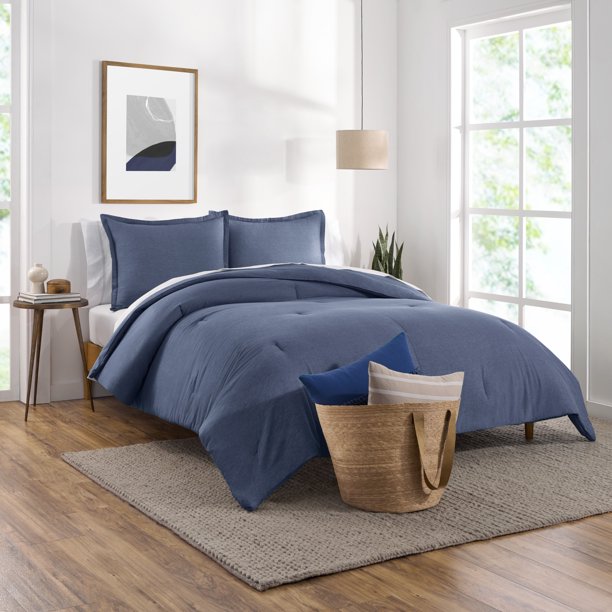 denim comforter on bed in clean modern room