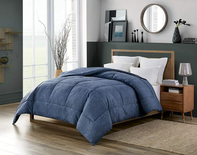 denim comforter on bed in moody clean room
