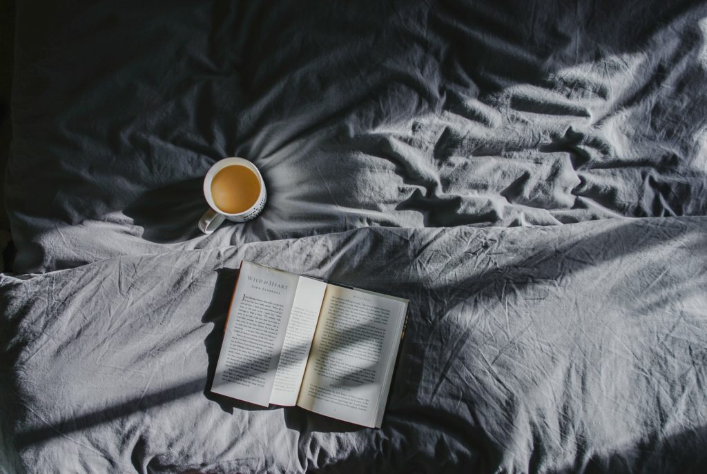 denim sheets styled with coffee cup and book