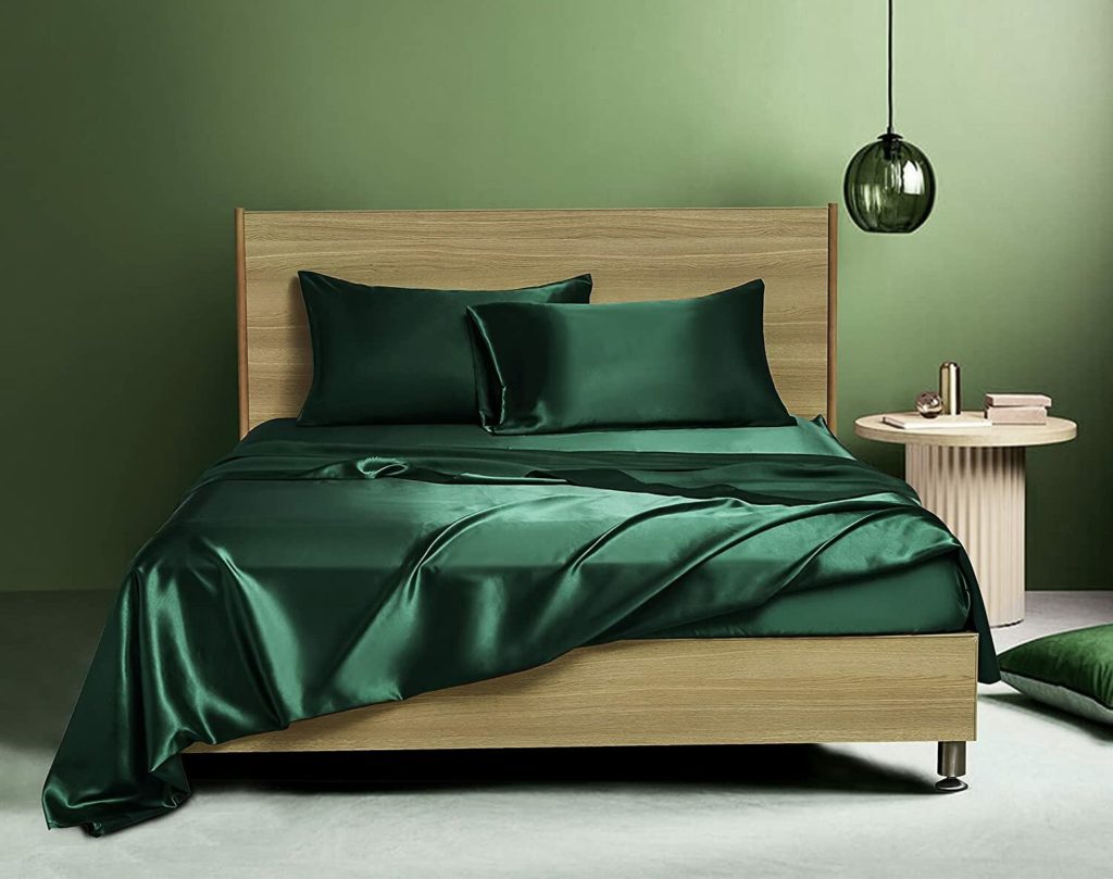 emerald green satin sheets on bed in green modern room