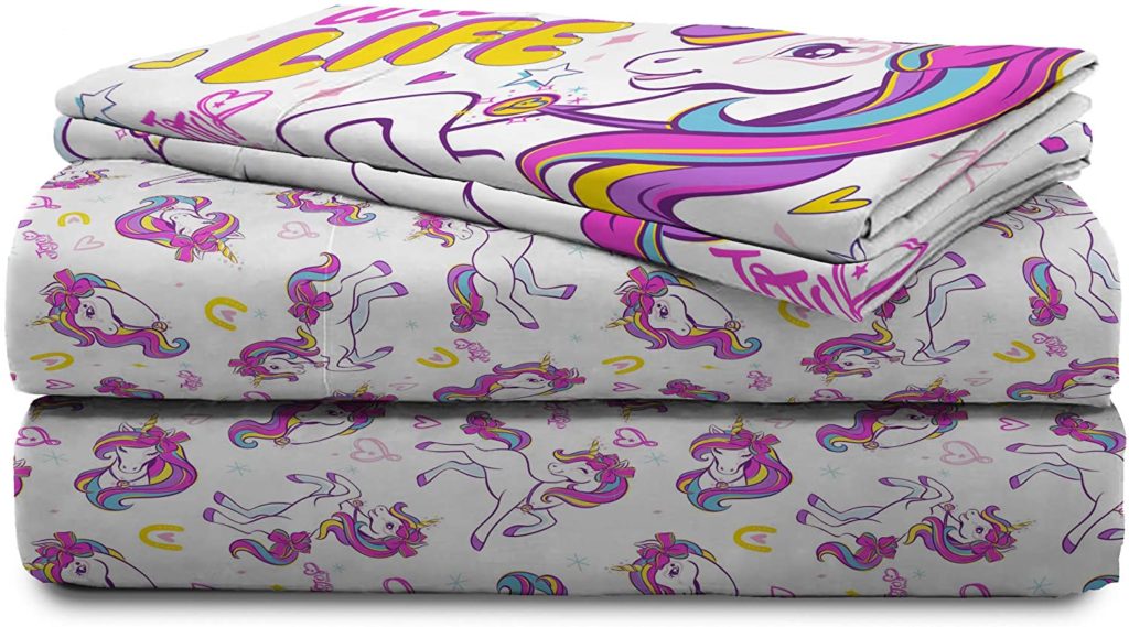folded white and colorful unicorn comforter set