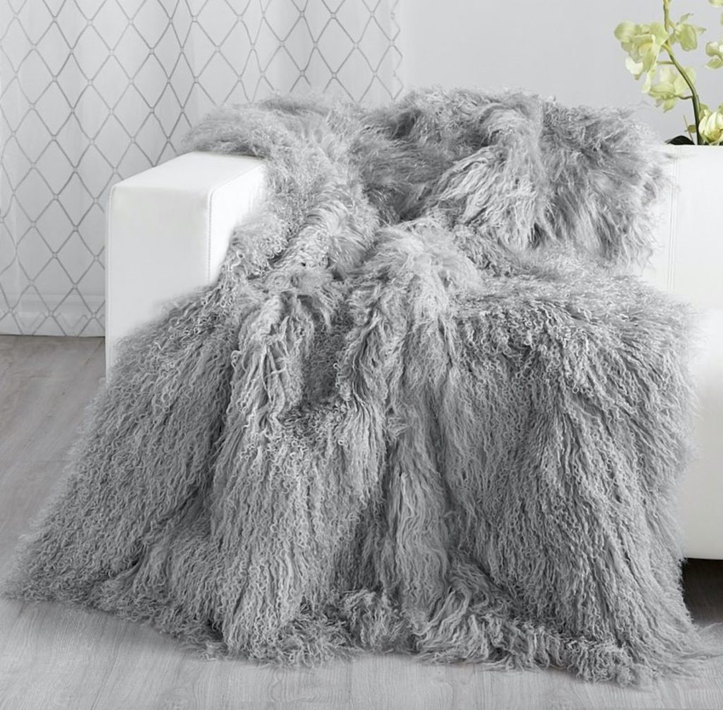 grey fur blanket draped over chair