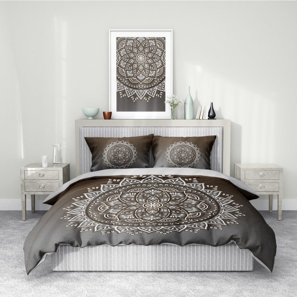 grey patterned boho comforter with artwork above bed