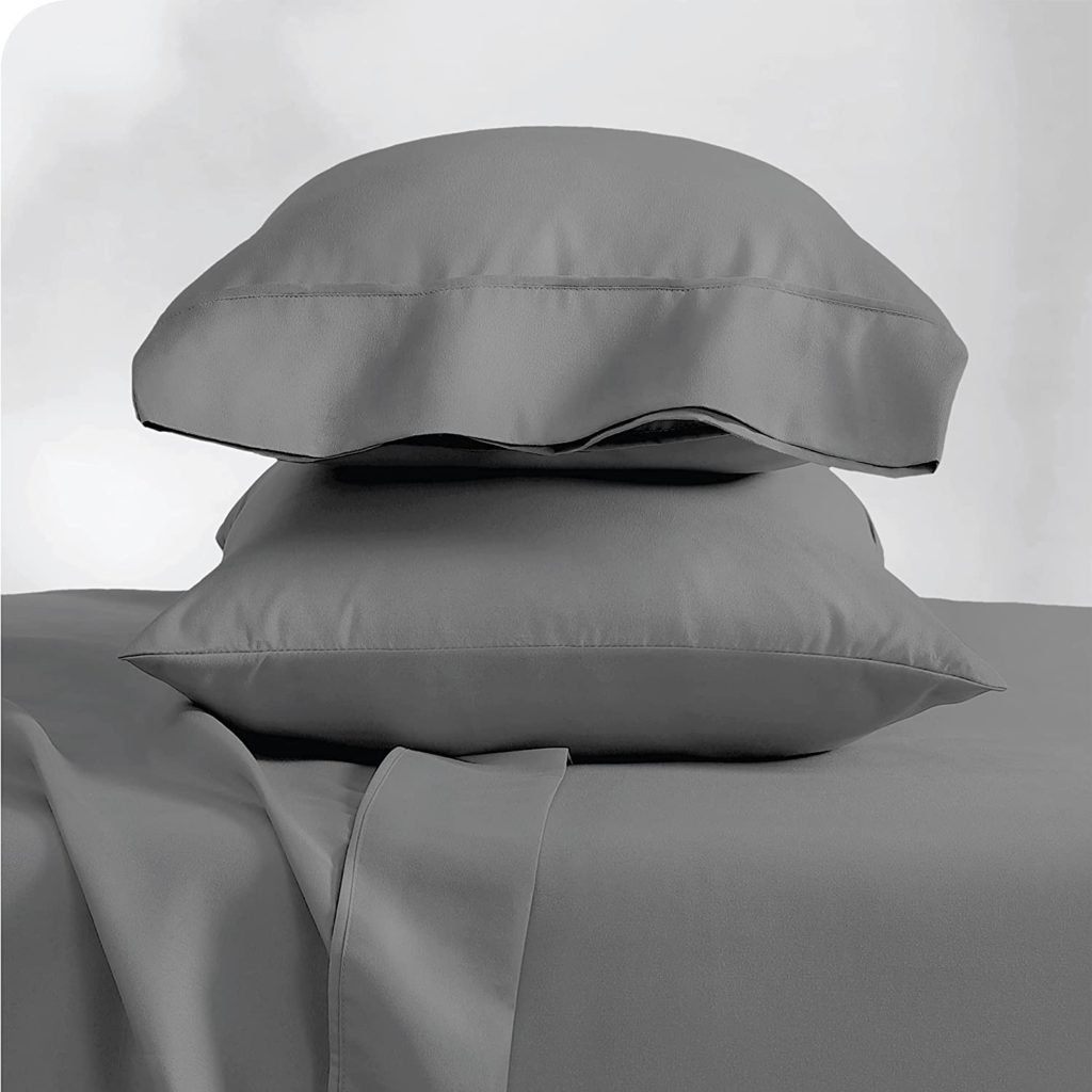 grey pillows resting on grey bedding