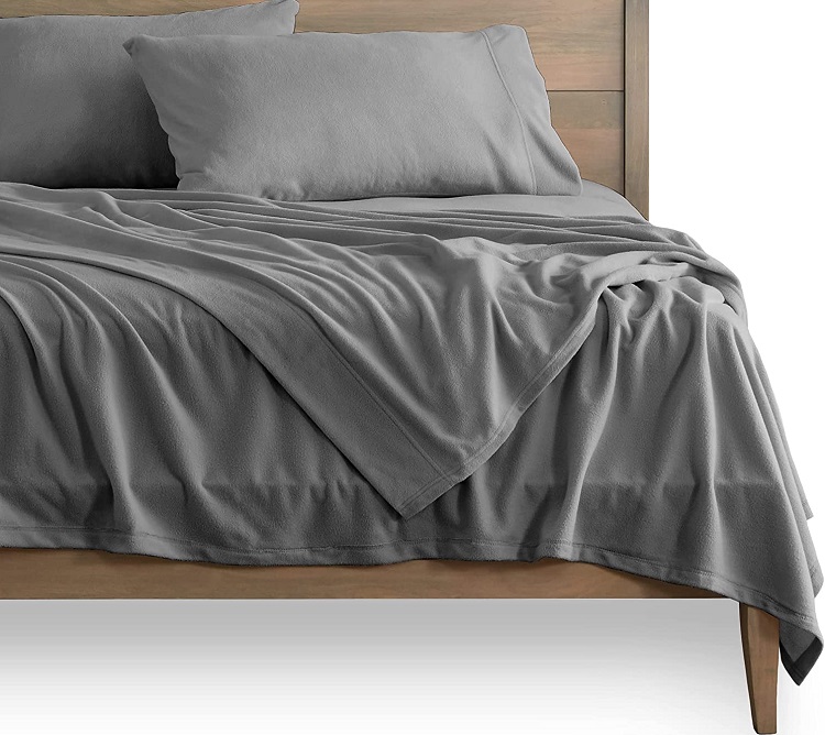 grey sheets on modern bed