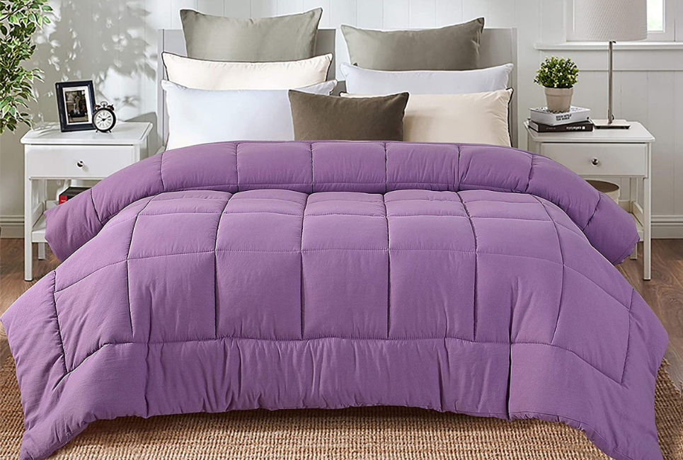 lavender comforter on neatly made bed