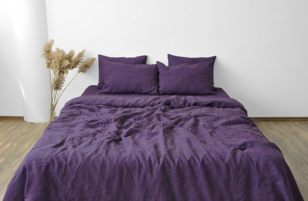 linen purple comforter on bed