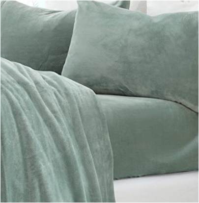 bed made with sage green fleece sheets