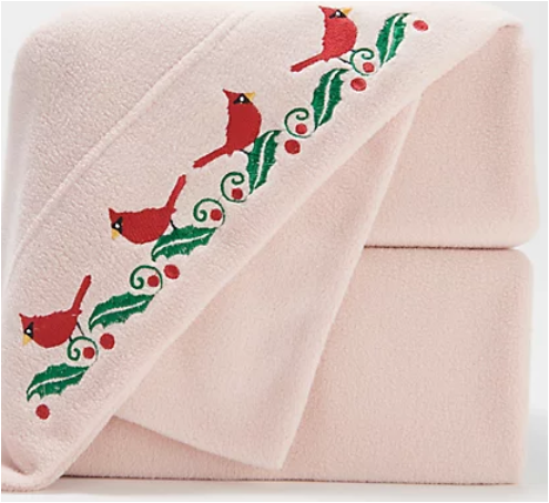pink fleece sheets folded showing cardinal and ivy detail on trim