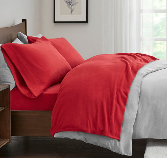 bed made with fleeze red sheets and a grey comforter