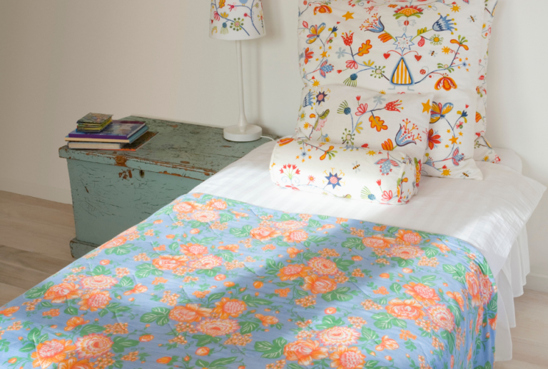 multicolored floral sheets on twin bed