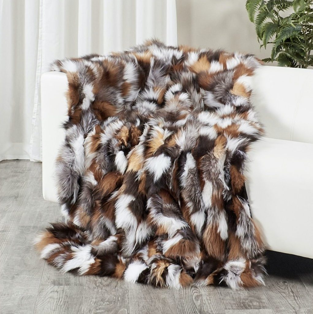 multicolored fur throw blanket draped over couch