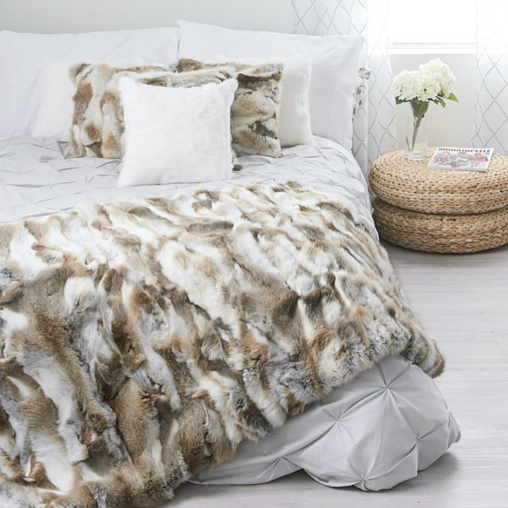 multicolored fur throw blanket on bed