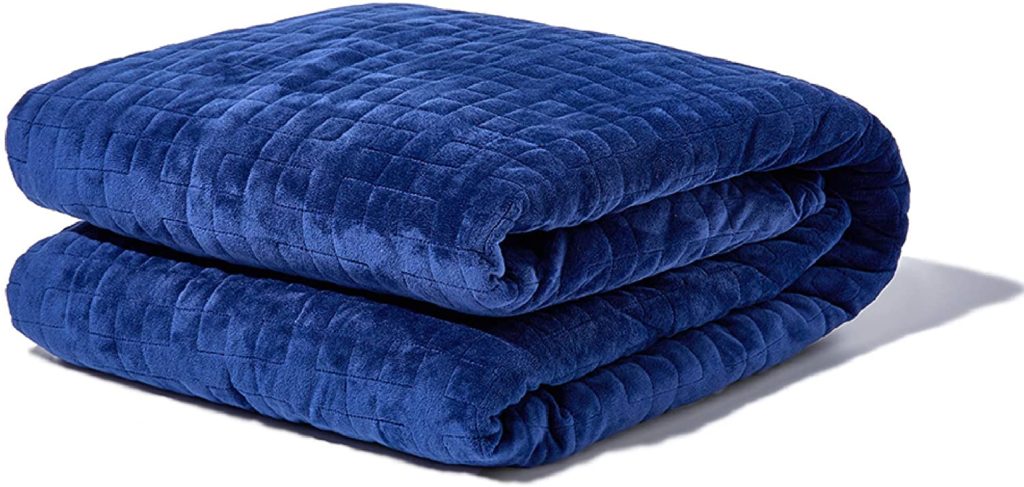 neatly folded blue velvet blanket