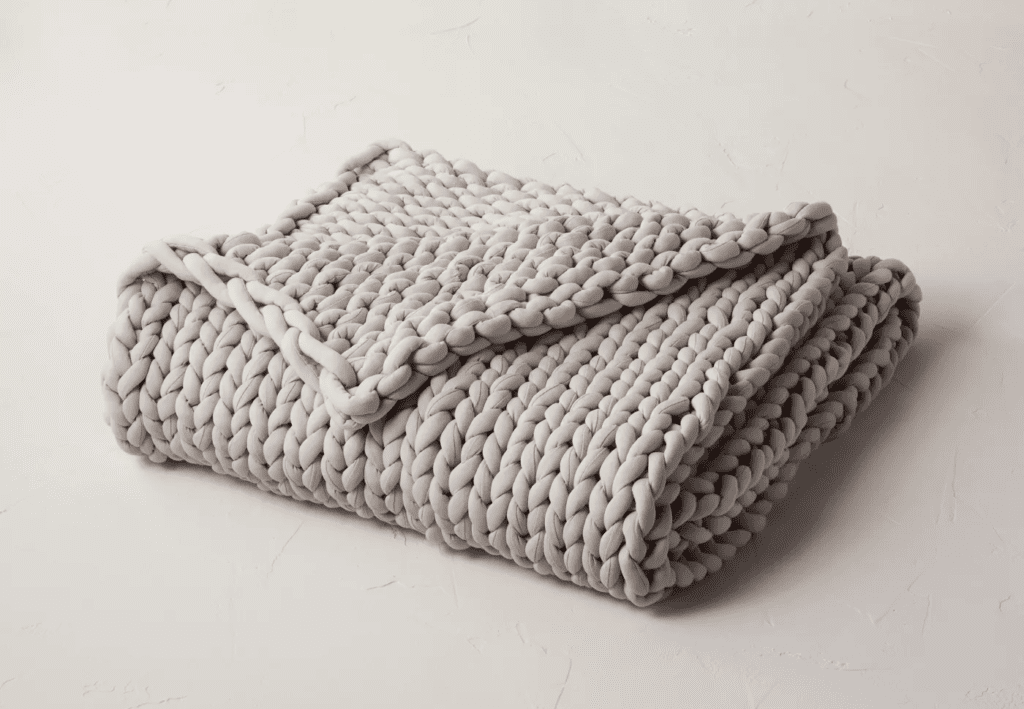 neatly folded grey knit blanket