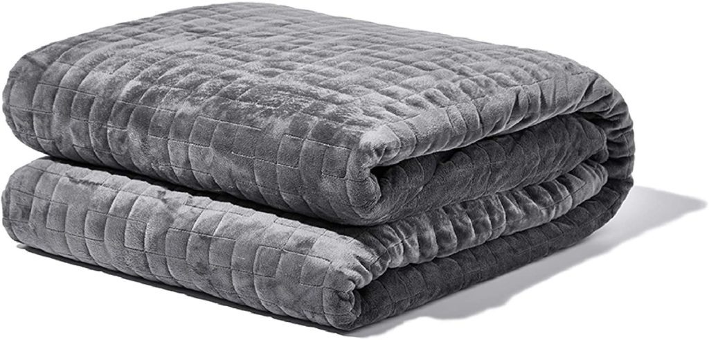 neatly folded grey velvet blanket
