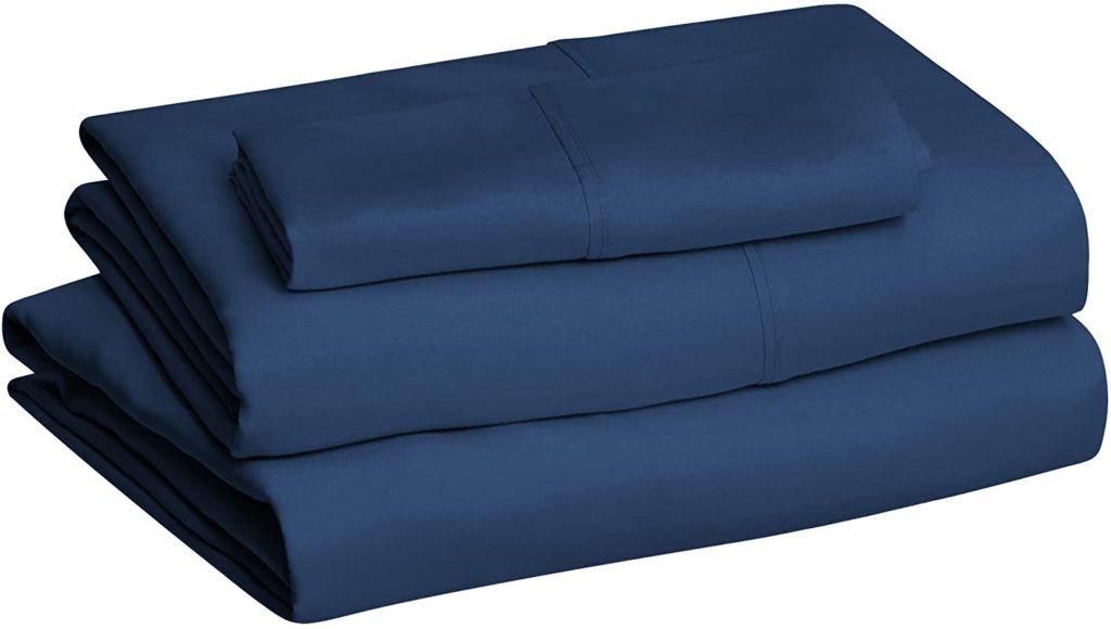 neatly folded navy blue sheet set