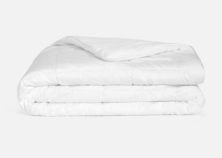 neatly folded white comforter
