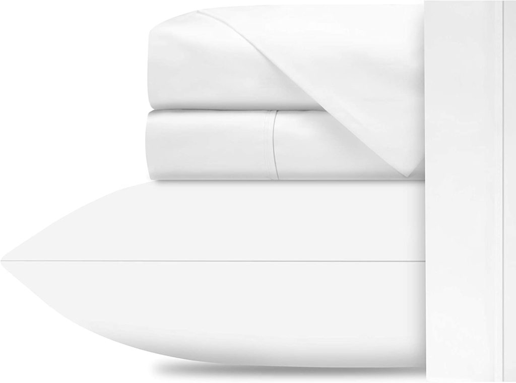 neatly folded white stacked sheet set on pillow