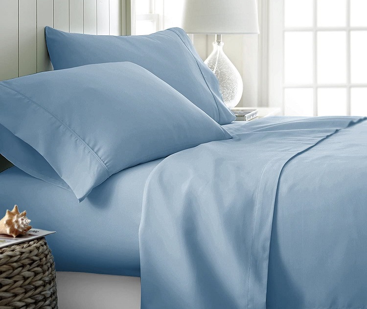 neatly made bed with sky blue bedding