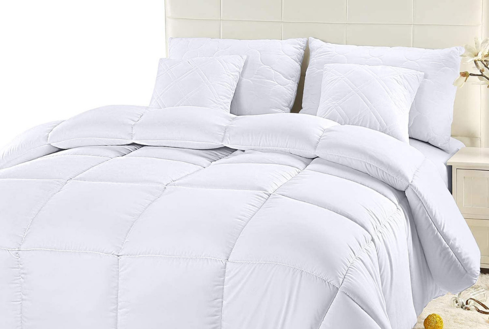 neatly made bed with white box stitch comforter
