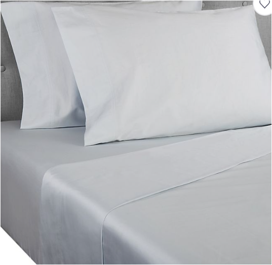 Light grey sheets and pillow on bed