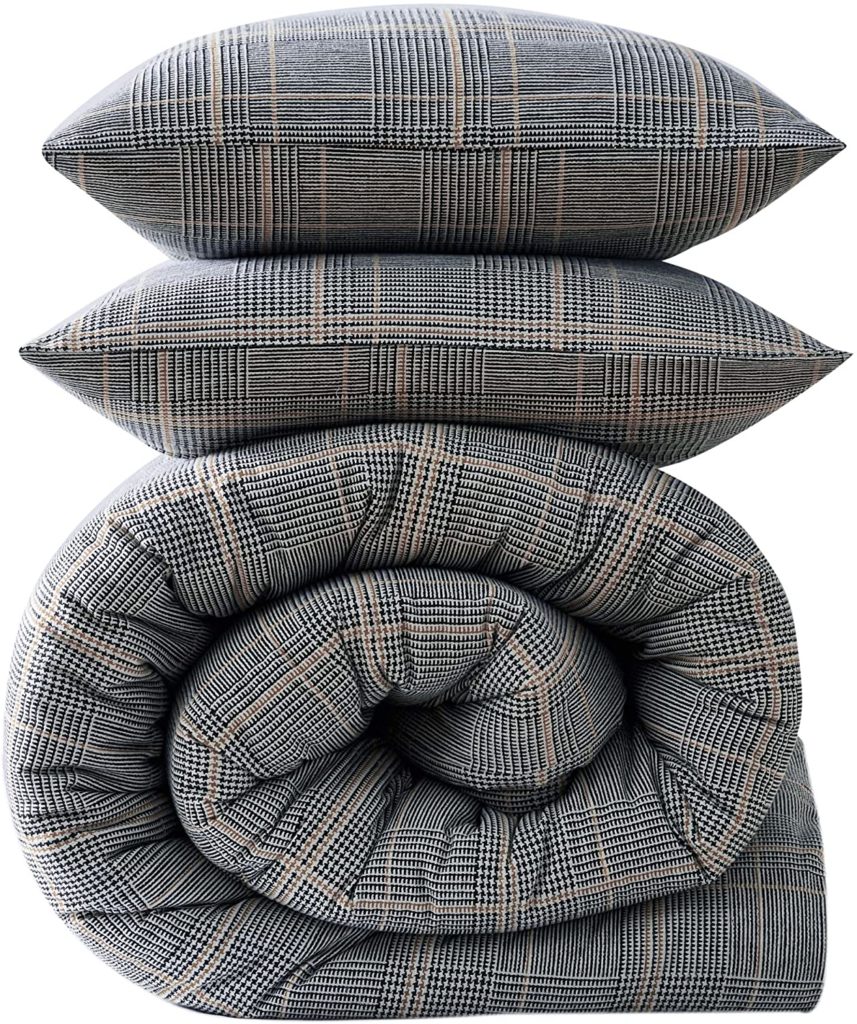 plaid neutral flannel comforter and pillows stacked neatly