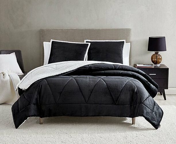 plush grey and sherpa bedding on bed
