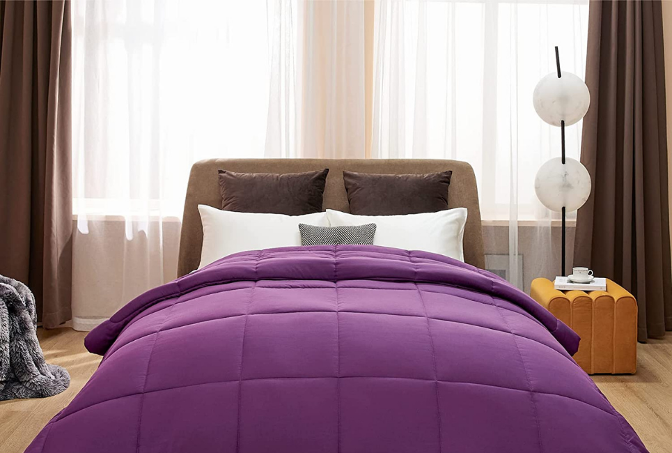 purple comforter on bed