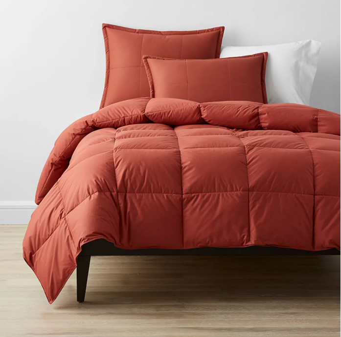 reddish orange comforter on bed