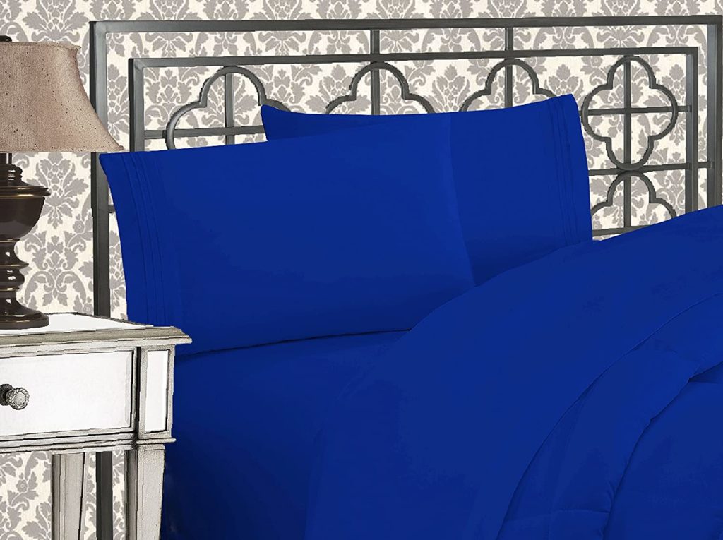 rendering of bed in elegant room with royal blue sheets