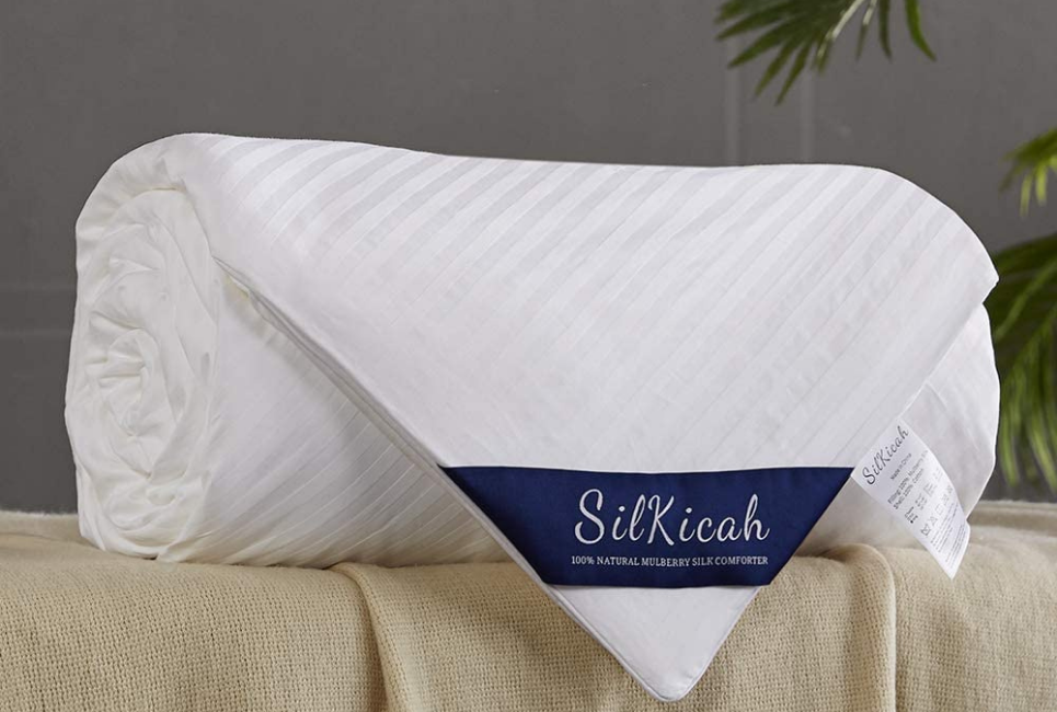 rolled up white comforter with brand label shown