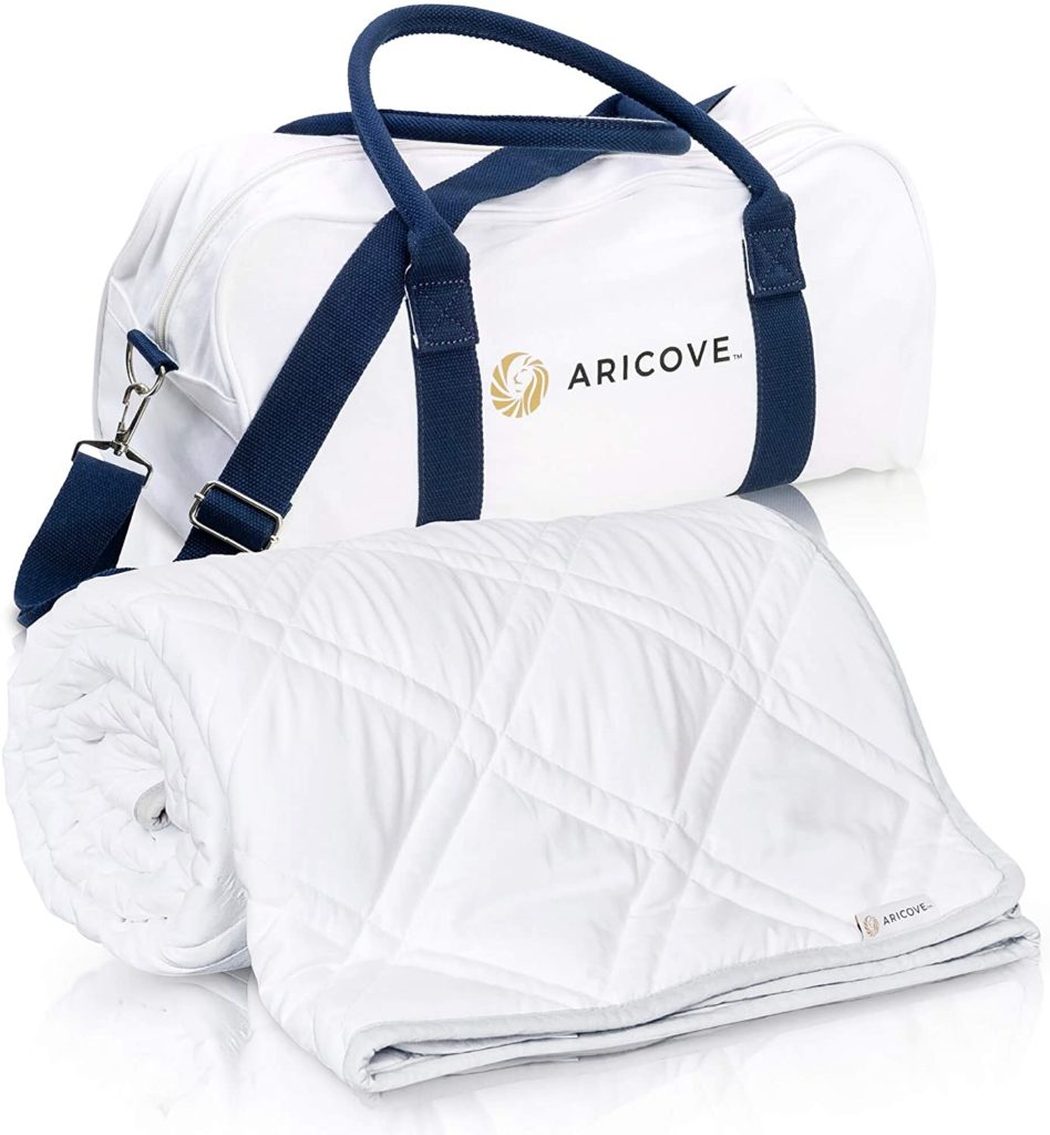 rolled white blanket with duffel bag reading ARICOVE