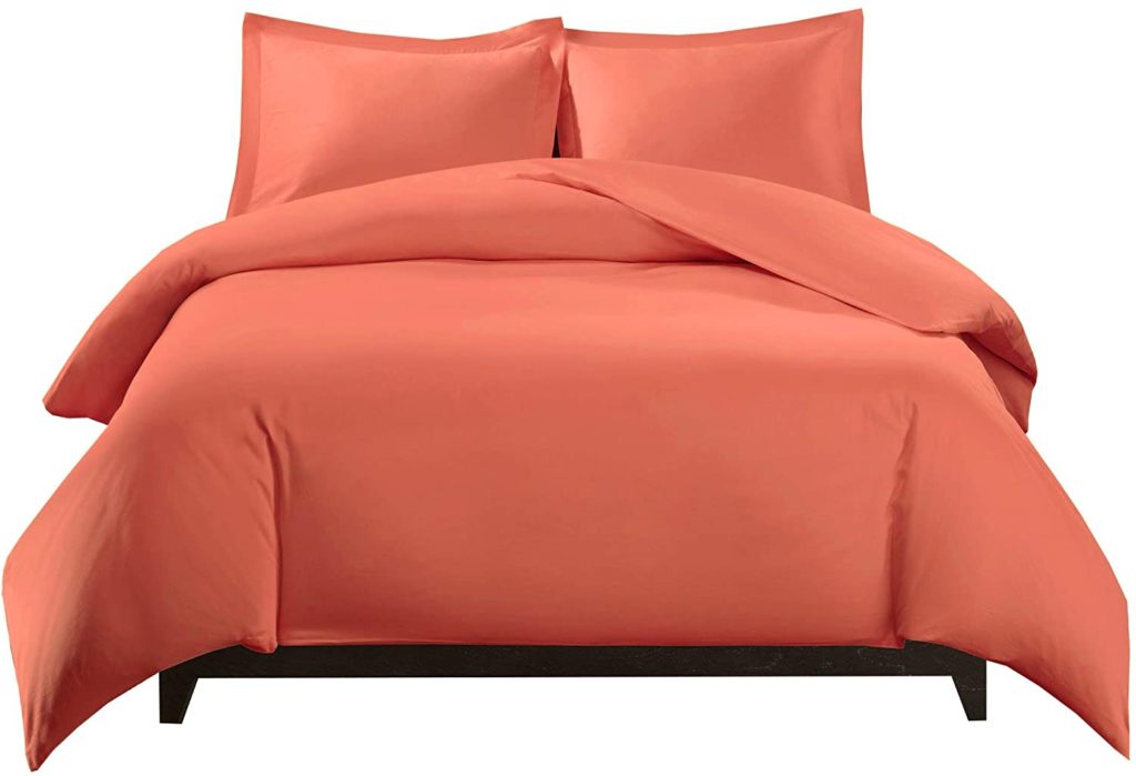 salmon orange comforter on bed