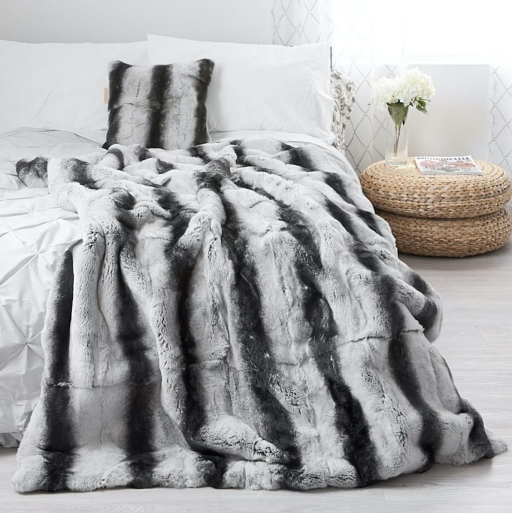 striped grey fur comforter on bed