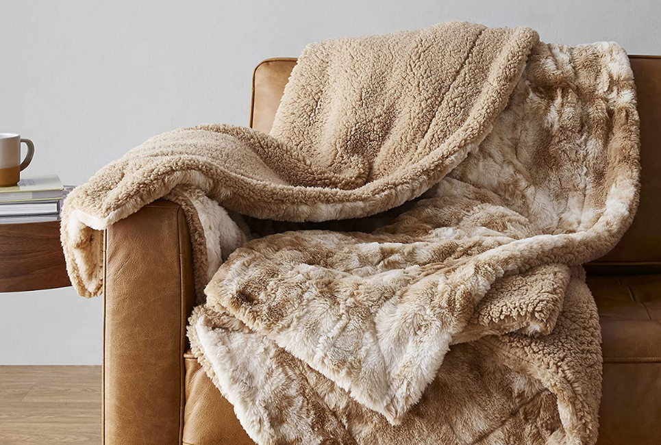 tan faux fur comforter draped over chair