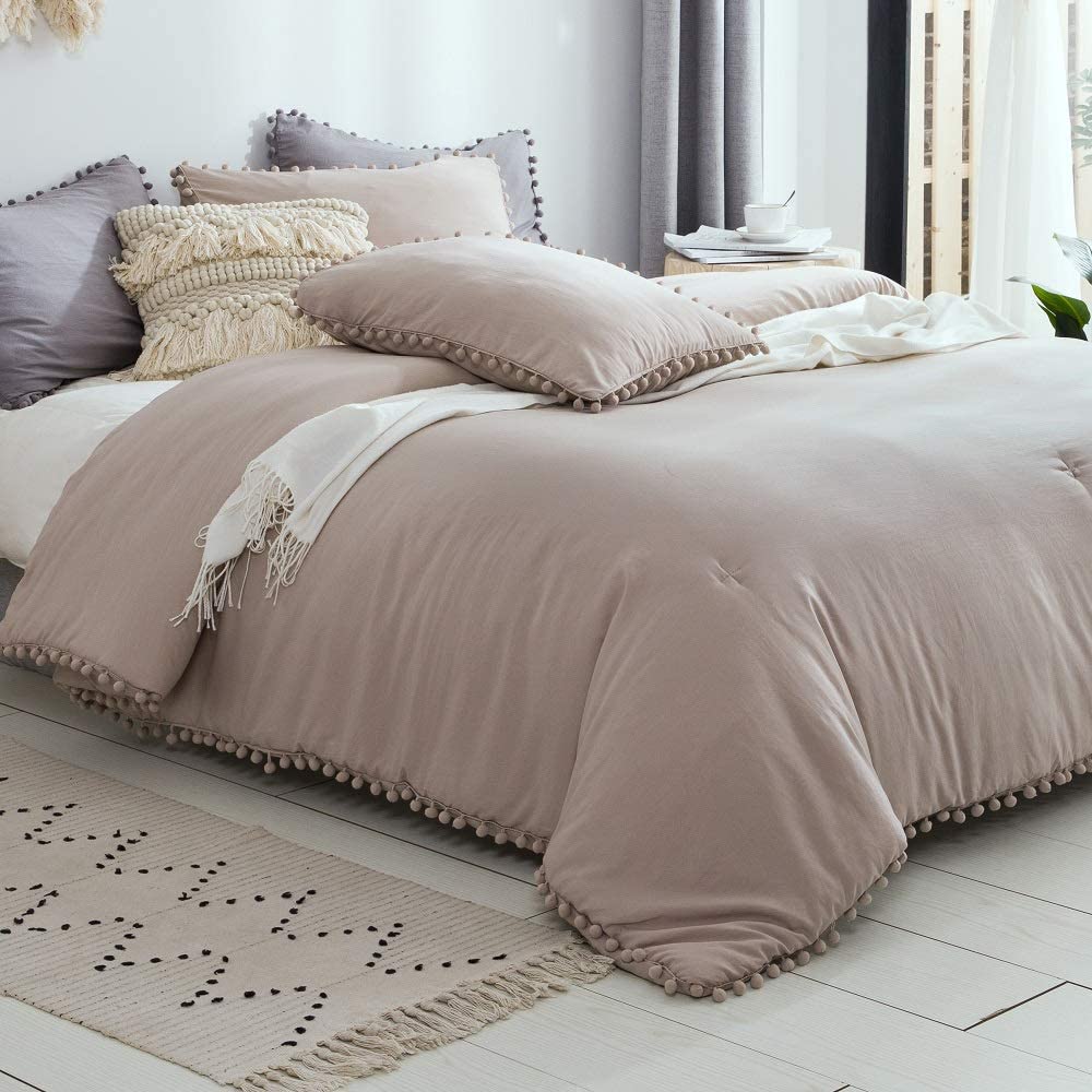 taupe boho comforter with pom pom detail