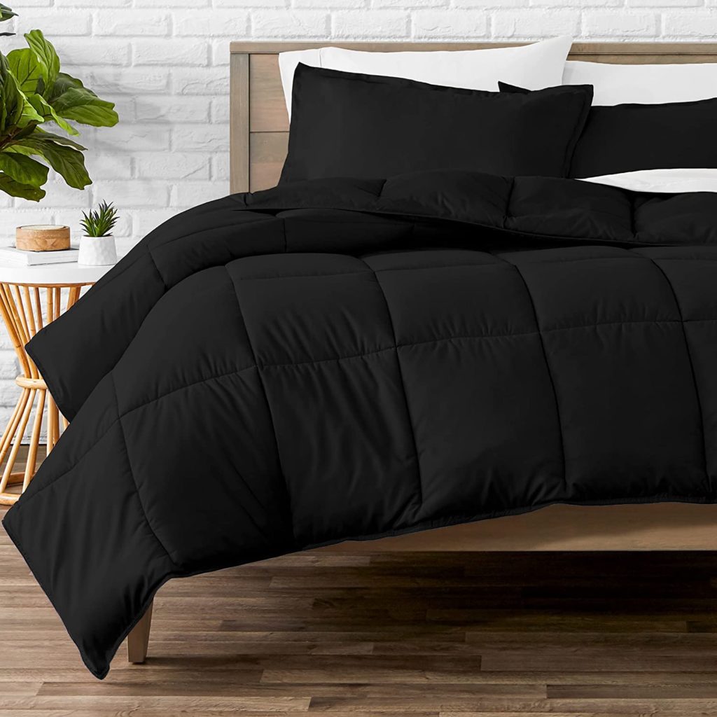 trendy bed with black bedding