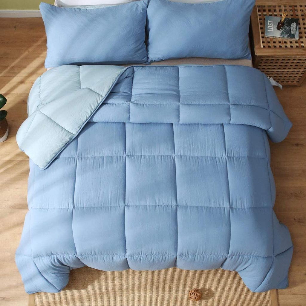 two toned blue reversible comforter on bed