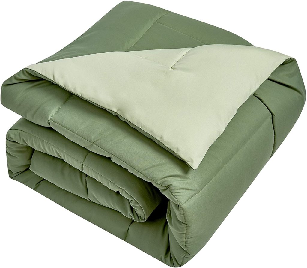 two toned green reversible comforter folded neatly