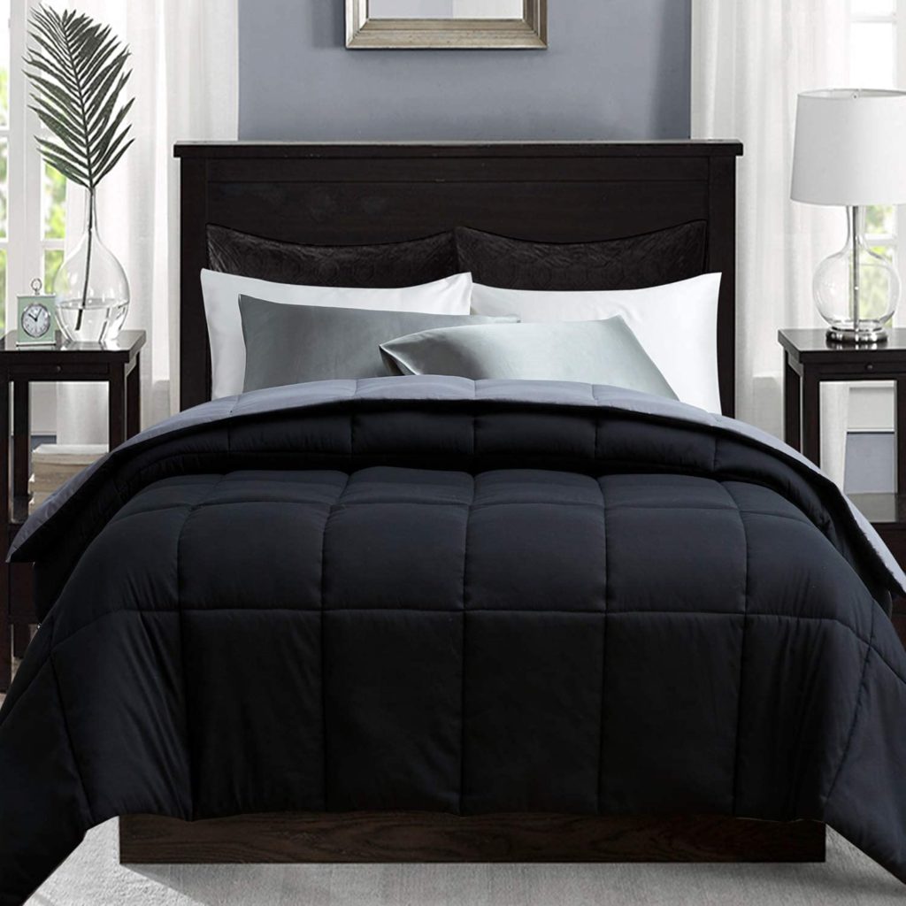 grey and black reversible comforter on bed in modern room