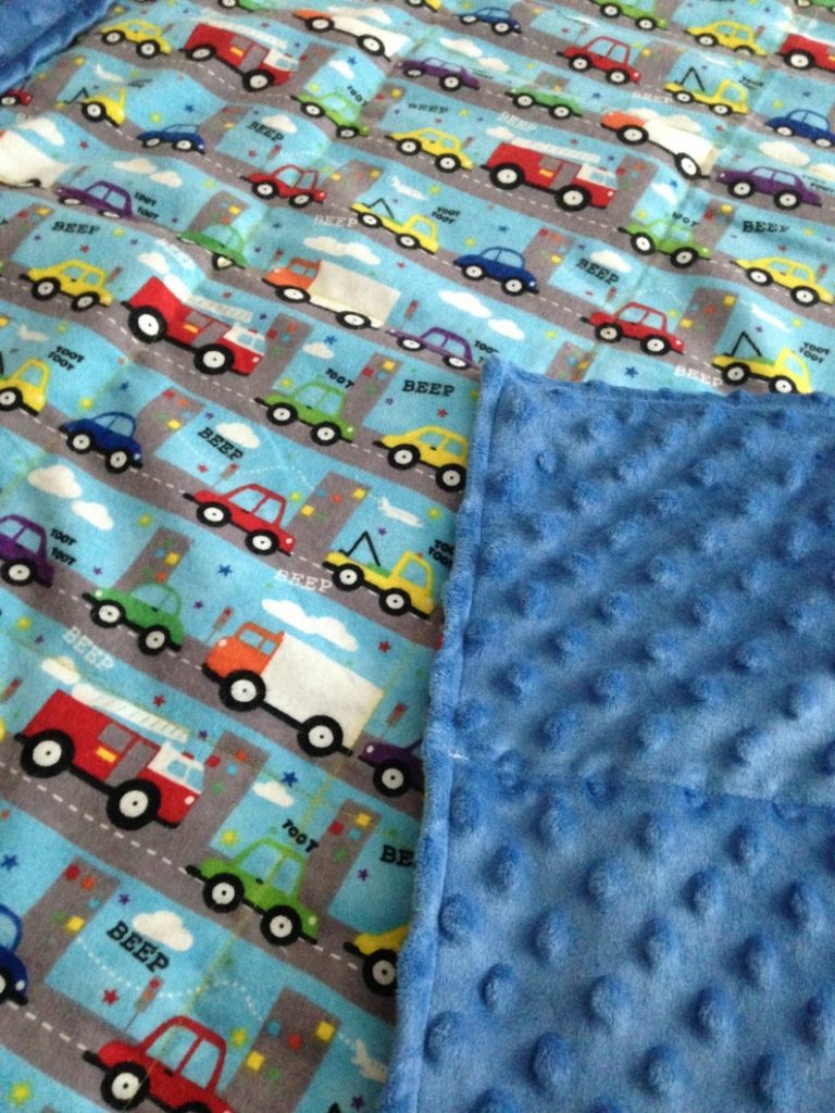 weighted blanket with colorful truck illustration pattern