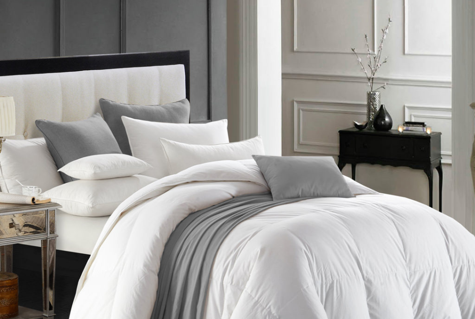 white and grey bedding with decorative pillows