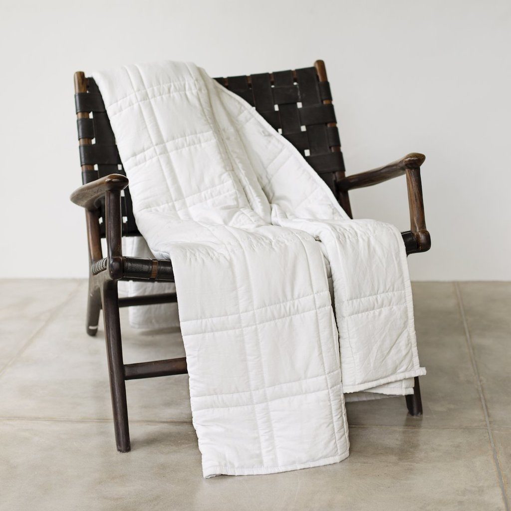 white blanket draped over wooden chair