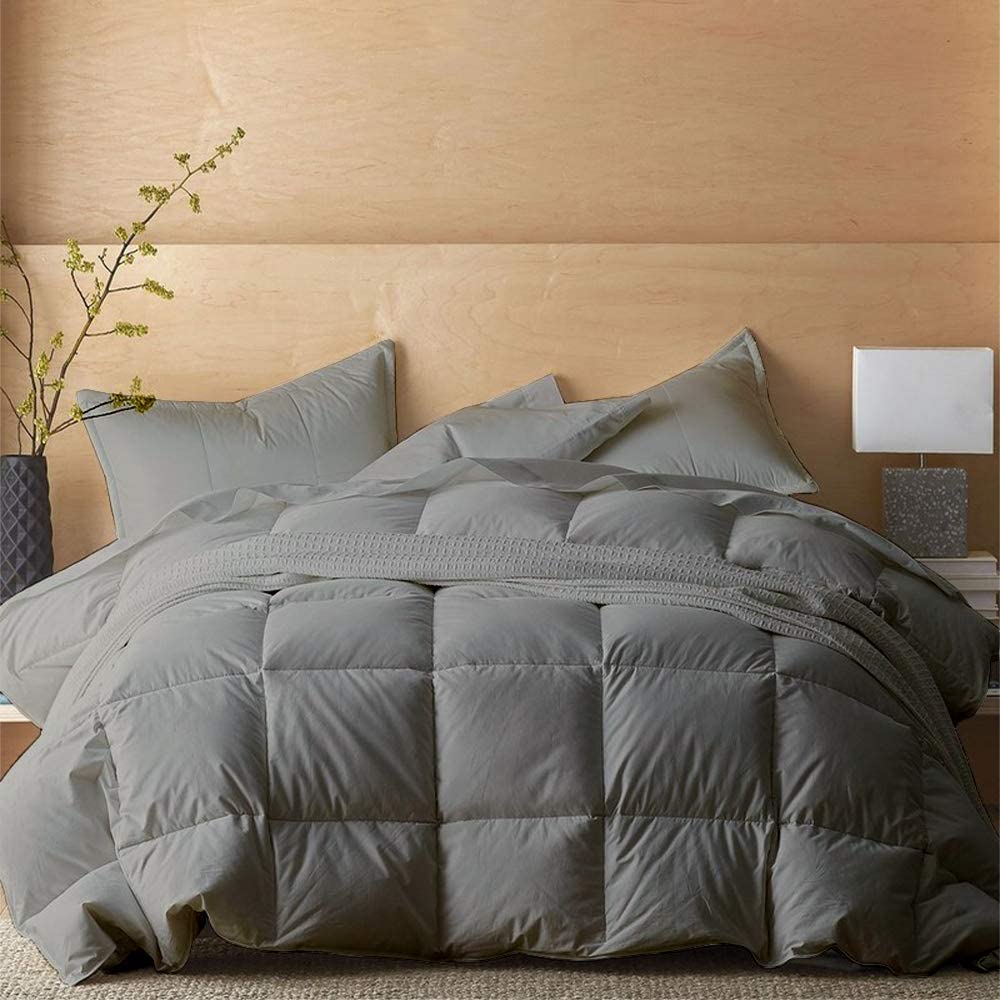 grey cotton comforter and pillows on bed