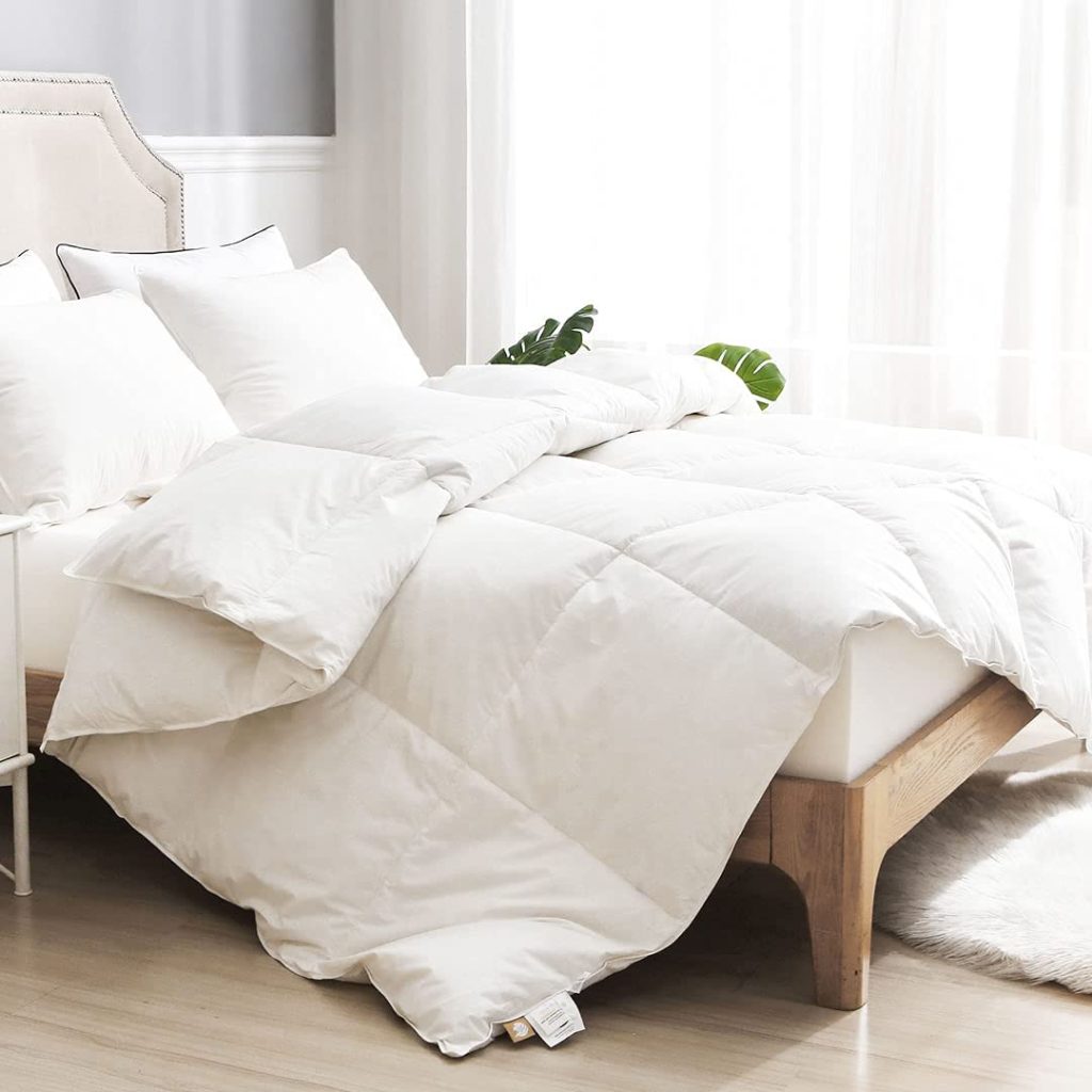 white cotton comforter on unmade bed